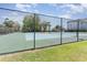 Fenced tennis court surrounded by lush greenery, offering a great recreational space at 9779 Leyland Dr. # 3, Myrtle Beach, SC 29572