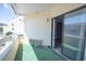 View from balcony showing the sliding glass doors and an air conditioner at 1100 Possum Trot Rd. # H-233, North Myrtle Beach, SC 29582