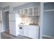 Kitchenette with white appliances, tile backsplash, white cabinets and ample counter space at 1100 Possum Trot Rd. # H-233, North Myrtle Beach, SC 29582