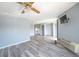 Spacious living room with gray walls, modern flooring, ceiling fan, and sliding glass doors to balcony at 1100 Possum Trot Rd. # H-233, North Myrtle Beach, SC 29582