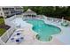 Aerial view of the community pool and white fence with picnic tables and chairs at 1100 Possum Trot Rd. # H-233, North Myrtle Beach, SC 29582