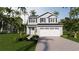 Charming two-story home with a large garage, lush landscaping and palm trees at 1120 Oak Meadow Dr., Conway, SC 29526