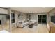 Comfortable living room with white sofas, natural light, and an open layout to the kitchen and dining area at 1120 Oak Meadow Dr., Conway, SC 29526