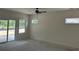 Bright, unfinished bedroom boasting a sliding glass door, two windows and neutral walls at 122 Westfield Circle, Conway, SC 29526