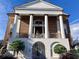 Striking brick home with prominent white columns and a covered entrance exudes classic architectural charm at 122 Westfield Circle, Conway, SC 29526