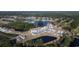 Aerial view of a lakeside community with lush trees and blue houses at 1228 Barrington Way, Conway, SC 29526