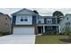Charming two-story home with blue siding, stone accents, and a well-maintained front yard at 1228 Barrington Way, Conway, SC 29526