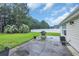 Large backyard featuring patio, green grass, fenced in yard and mature trees at 137 Maiden Ln., Myrtle Beach, SC 29588