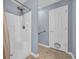 Bright bathroom featuring walk-in shower, tile flooring, neutral paint and grab bar at 137 Maiden Ln., Myrtle Beach, SC 29588