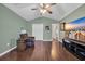 Cozy bedroom with wood floors, ceiling fan, and plenty of natural light at 137 Maiden Ln., Myrtle Beach, SC 29588