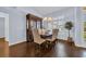Cozy dining room with hardwood floors, complemented by a dark wood china cabinet and chandelier at 137 Maiden Ln., Myrtle Beach, SC 29588