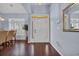 Bright foyer with hardwood floors, a charming mirror, and sidelights on the front door at 137 Maiden Ln., Myrtle Beach, SC 29588