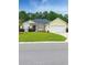 Charming single-story home with manicured lawn, a lovely palm tree and an attached two car garage at 137 Maiden Ln., Myrtle Beach, SC 29588