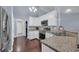 Modern kitchen with white cabinets, granite countertops, and stainless steel appliances at 137 Maiden Ln., Myrtle Beach, SC 29588