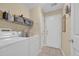 Clean laundry room with washer, dryer, utility sink, shelving and access to the garage at 137 Maiden Ln., Myrtle Beach, SC 29588