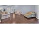 Bright living room featuring wood floors, a cream-colored couch, and a comfortable chair at 137 Maiden Ln., Myrtle Beach, SC 29588