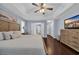 Bright main bedroom featuring hardwood flooring, ceiling fan, sitting area and access to the ensuite bathroom at 137 Maiden Ln., Myrtle Beach, SC 29588