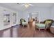 Bright sunroom with hardwood flooring, wicker chairs, view to the living spaces and access to the backyard at 137 Maiden Ln., Myrtle Beach, SC 29588