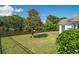 Features a tranquil backyard with a protective fence overlooking a serene pond, with a mature tree enhancing the landscape at 1388 Gailard Dr., Conway, SC 29526
