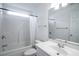 Bright, white bathroom features a shower-tub combo and a classic vanity with ample lighting at 1388 Gailard Dr., Conway, SC 29526