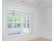 Well-lit bedroom featuring a ceiling fan and large windows overlooking the outdoor patio at 1388 Gailard Dr., Conway, SC 29526