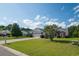Attractive single-story home features a lush green lawn and long driveway leading to an attached two-car garage at 1388 Gailard Dr., Conway, SC 29526