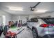 Well-lit garage with parked SUV, garage door mechanism, ladder, and door to outside at 1388 Gailard Dr., Conway, SC 29526