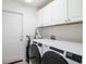 Laundry room with large washer and dryer, white cabinets, and exterior access at 1388 Gailard Dr., Conway, SC 29526