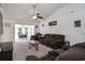 Comfortable living room features plush brown sofas, neutral carpeting, and a ceiling fan at 1388 Gailard Dr., Conway, SC 29526