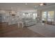 Open-concept living room features hardwood floors, ample seating, and large windows for natural light at 148 Splendor Circle, Murrells Inlet, SC 29576