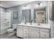 Bathroom featuring a double vanity, neutral walls, and a shower-tub combo at 1517 Hope Pointe Dr, North Myrtle Beach, SC 29582