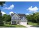 Charming two-story home features a two-car garage, light gray siding, and a well-manicured lawn at 1517 Hope Pointe Dr, North Myrtle Beach, SC 29582