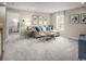 Comfortable living room featuring neutral decor, plush carpet, and large windows for natural light at 1517 Hope Pointe Dr, North Myrtle Beach, SC 29582