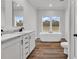 Bathroom featuring soaking tub, dual sinks, and hardwood floors at 1529 Bucksport Rd., Conway, SC 29527