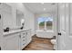 Bathroom featuring soaking tub, dual sinks, and hardwood floors at 1529 Bucksport Rd., Conway, SC 29527