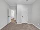 Bedroom featuring neutral walls and carpeting, with a bathroom visible through an open doorway at 1529 Bucksport Rd., Conway, SC 29527