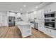 Bright, open-concept kitchen featuring white cabinetry, stainless steel appliances, and wood-look flooring at 1529 Bucksport Rd., Conway, SC 29527