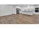 Bright, open-concept kitchen featuring white cabinetry, stainless steel appliances, and wood-look flooring at 1529 Bucksport Rd., Conway, SC 29527
