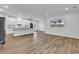 Open-concept kitchen featuring white cabinetry, stainless steel appliances, and wood-look flooring at 1529 Bucksport Rd., Conway, SC 29527