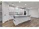 Bright, open-concept kitchen featuring white cabinetry, stainless steel appliances, and wood-look flooring at 1529 Bucksport Rd., Conway, SC 29527