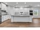 Bright, open-concept kitchen featuring white cabinetry, stainless steel appliances, and wood-look flooring at 1529 Bucksport Rd., Conway, SC 29527