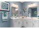 Elegant bathroom featuring dual sinks, white cabinets, decorative mirrors, and coastal-themed accents at 153 Stride Ct., Myrtle Beach, SC 29588