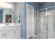 Clean bathroom with a white vanity, glass-enclosed shower, and blue accents for a refreshing feel at 153 Stride Ct., Myrtle Beach, SC 29588