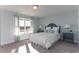Well-lit bedroom with a queen size bed and white bedding, side tables, lamps, and large window at 153 Stride Ct., Myrtle Beach, SC 29588