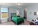 Charming bedroom with a twin bed featuring green soccer themed bedding, closet, and an outside view at 153 Stride Ct., Myrtle Beach, SC 29588