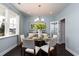 Bright dining room features a round table with seating for four, a chandelier, and a view to the outdoors at 153 Stride Ct., Myrtle Beach, SC 29588