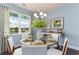 Bright dining room features a round glass table with seating, large window, and stylish decor for elegant meals at 153 Stride Ct., Myrtle Beach, SC 29588