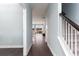 Bright hallway with hardwood floors leading to an open-concept living area and stairs to the upper level at 153 Stride Ct., Myrtle Beach, SC 29588