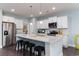 Modern kitchen with white cabinets, stainless steel appliances, and a large island for food preparation at 153 Stride Ct., Myrtle Beach, SC 29588