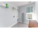 Bright laundry room with open shelving, window with shade, and gray tile floor at 153 Stride Ct., Myrtle Beach, SC 29588